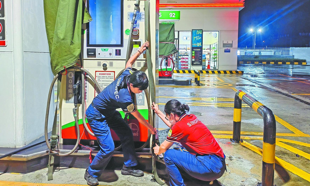 广东茂名石油南海加能站工作人员加固加油机。