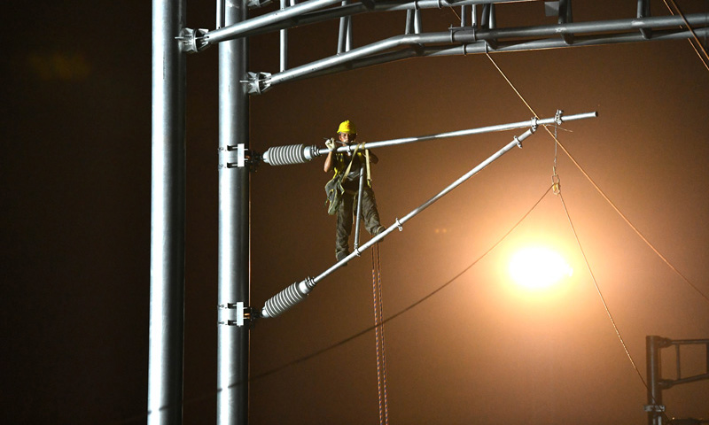 图为9月1日凌晨，中铁建电气化局南方公司施工人员在合安高铁集贤路线路所接触网拨接现场施工。（新华社记者 刘军喜 摄）