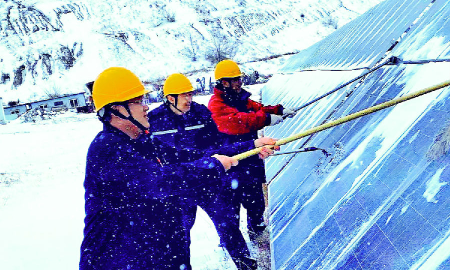 内蒙古能源项目筹建处建昌营光伏电站员工清理光伏板积雪，保障安全稳定运行。（李云涛 摄） 